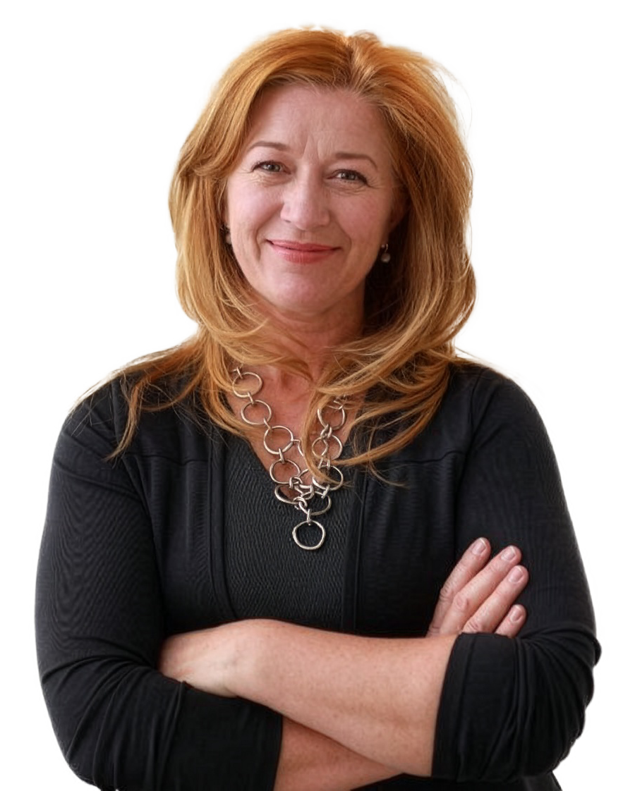 Smiling middle-aged woman with red hair wearing a black top and silver chain necklace, arms crossed