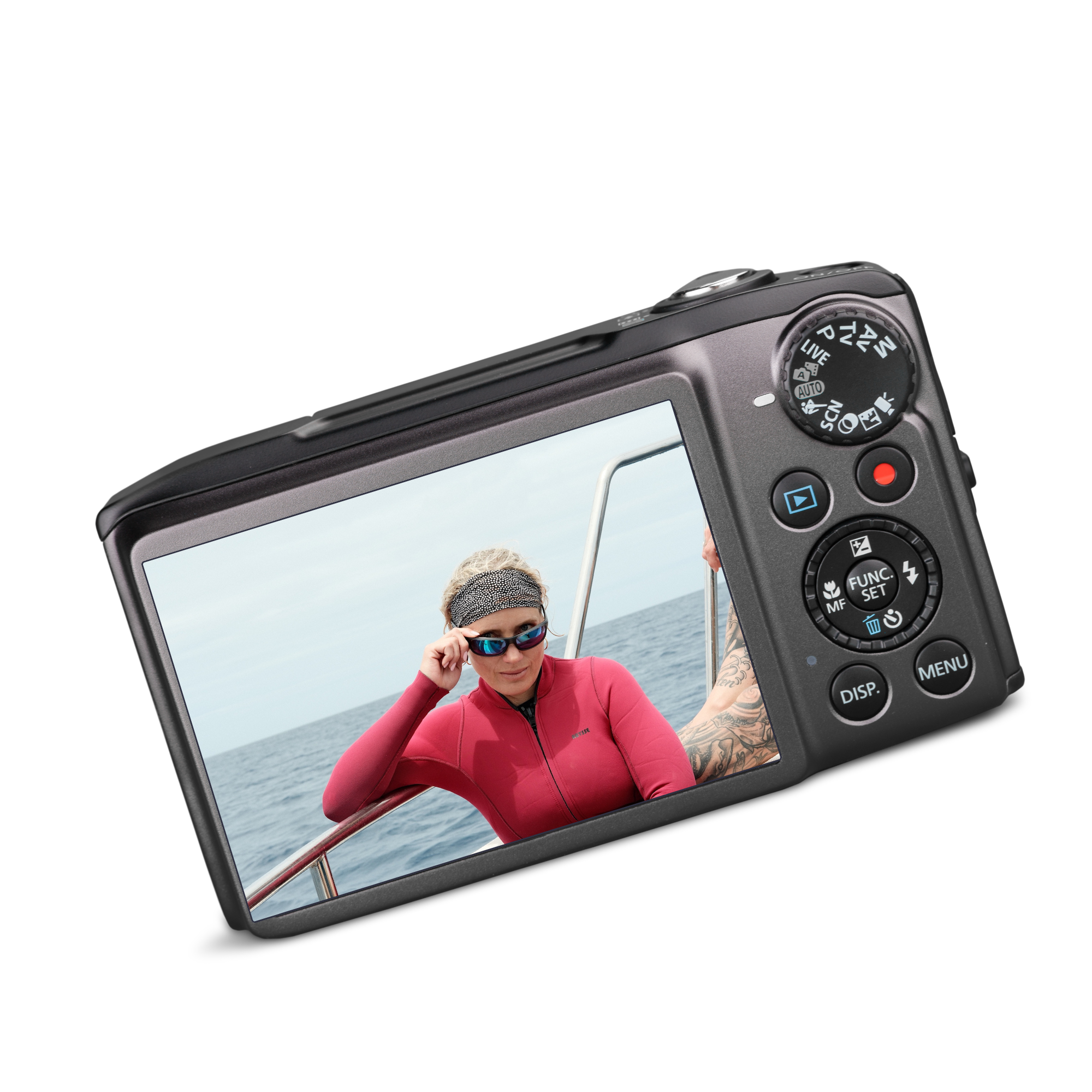 Close-up of a digital camera showing a woman in a red jacket and sunglasses, on a boat, with the ocean in the background.