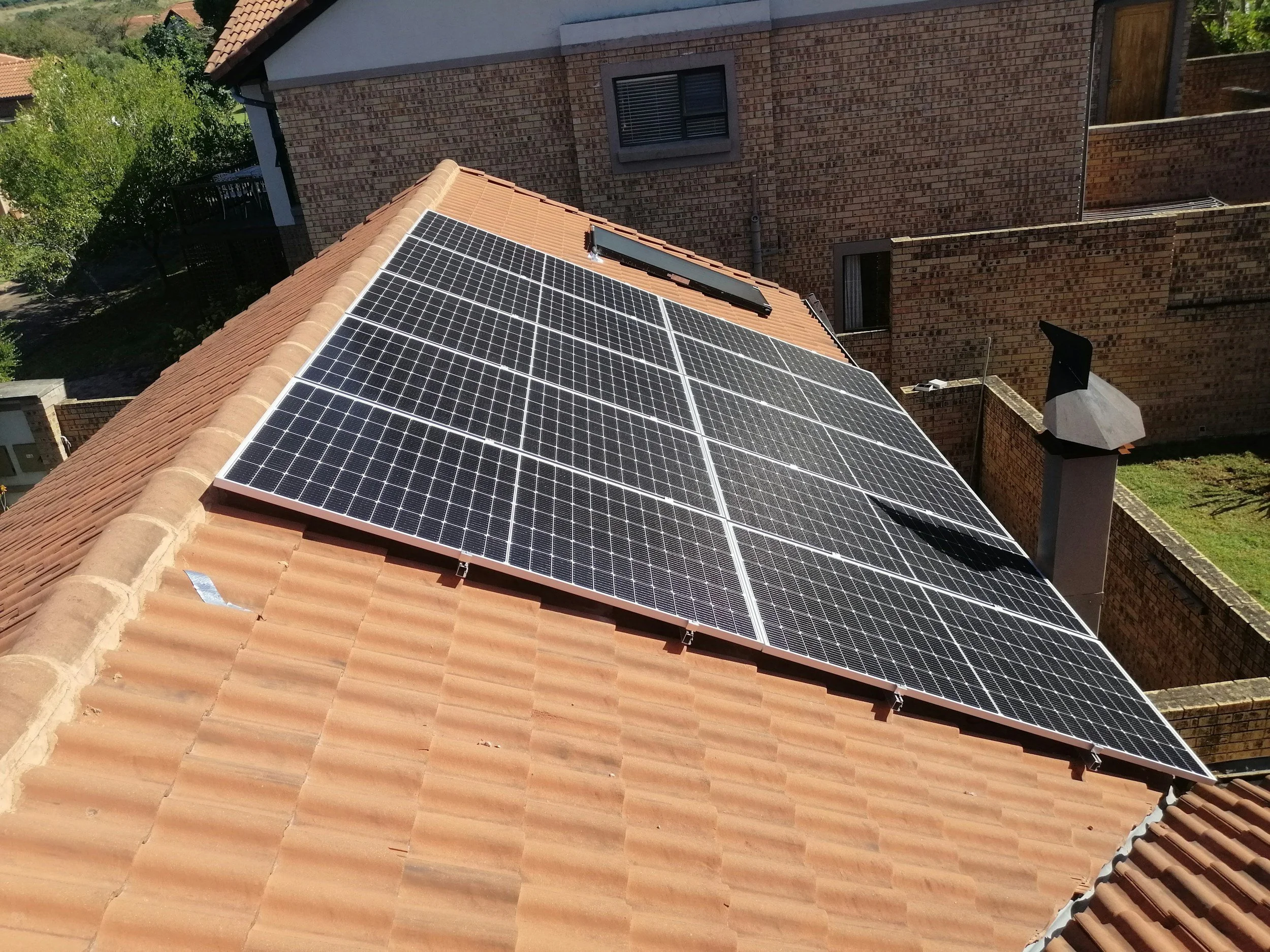 A house with solar panels installed on the tiled roof.