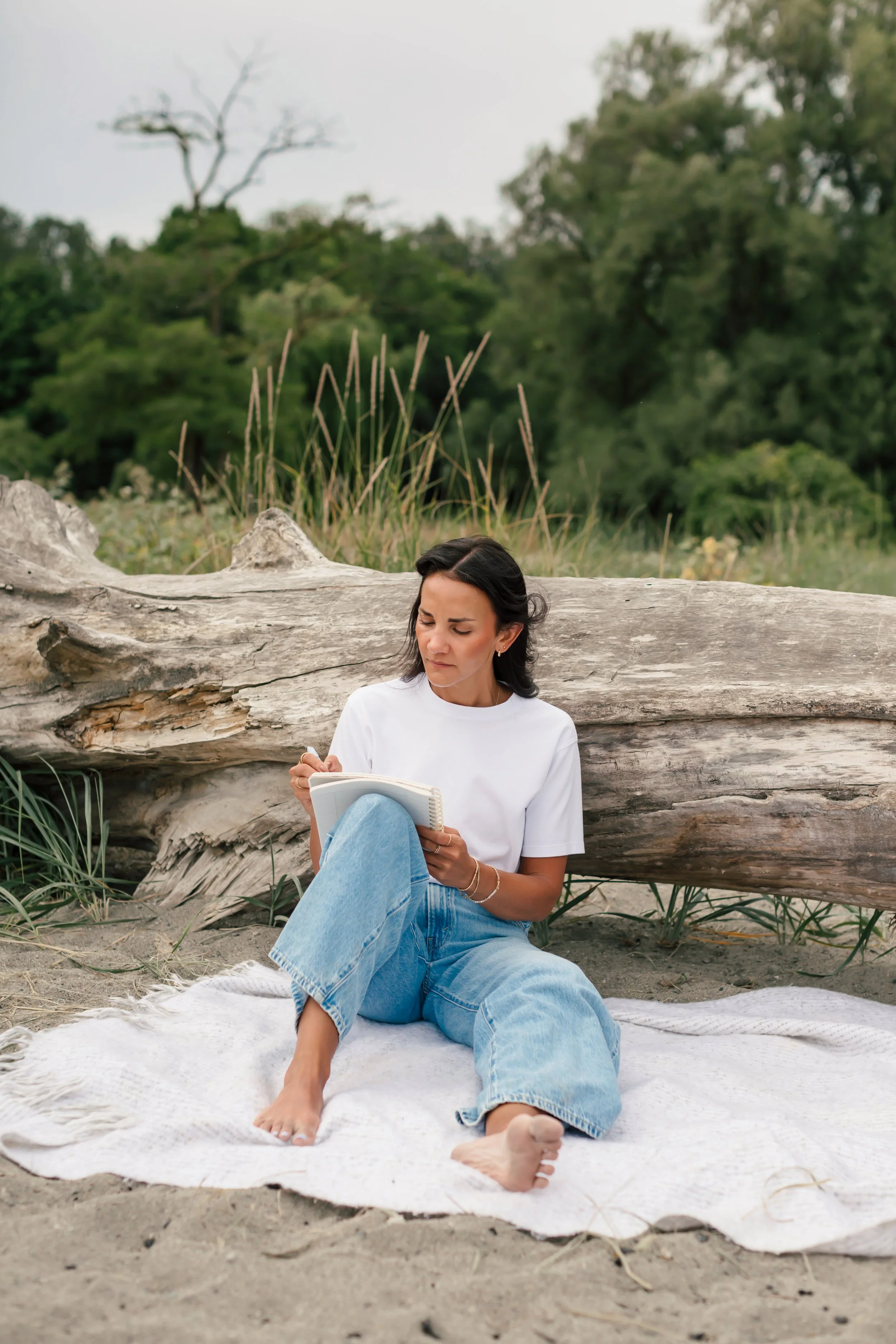 Psychedelic Integration Practitioner with journal and driftwood