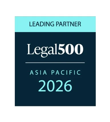 A digital graphic design with a blue and dark teal background. The top section says 'LEADING PARTNER' in black text. The middle section says 'Legal 500' in large white text, with '500' being bolded. The bottom section has 'ASIA PACIFIC 2026' in light blue text.