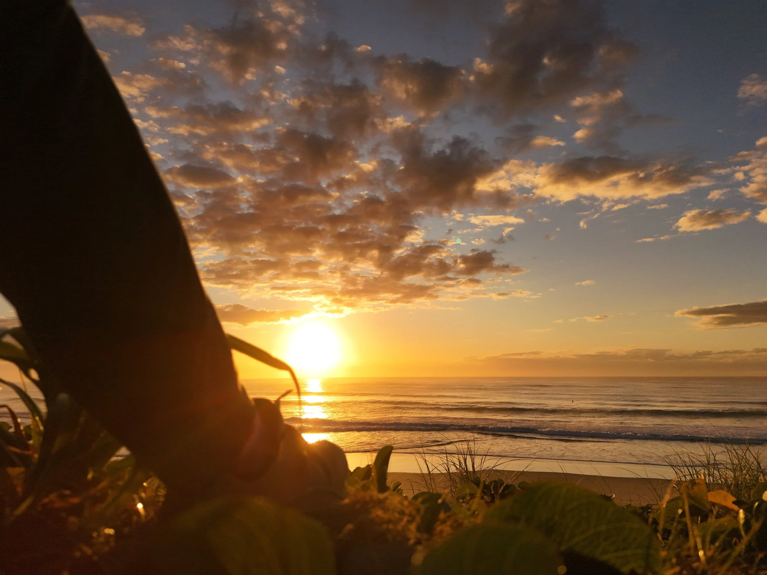 Watching the sunrise over the ocean and the colors in the sky.