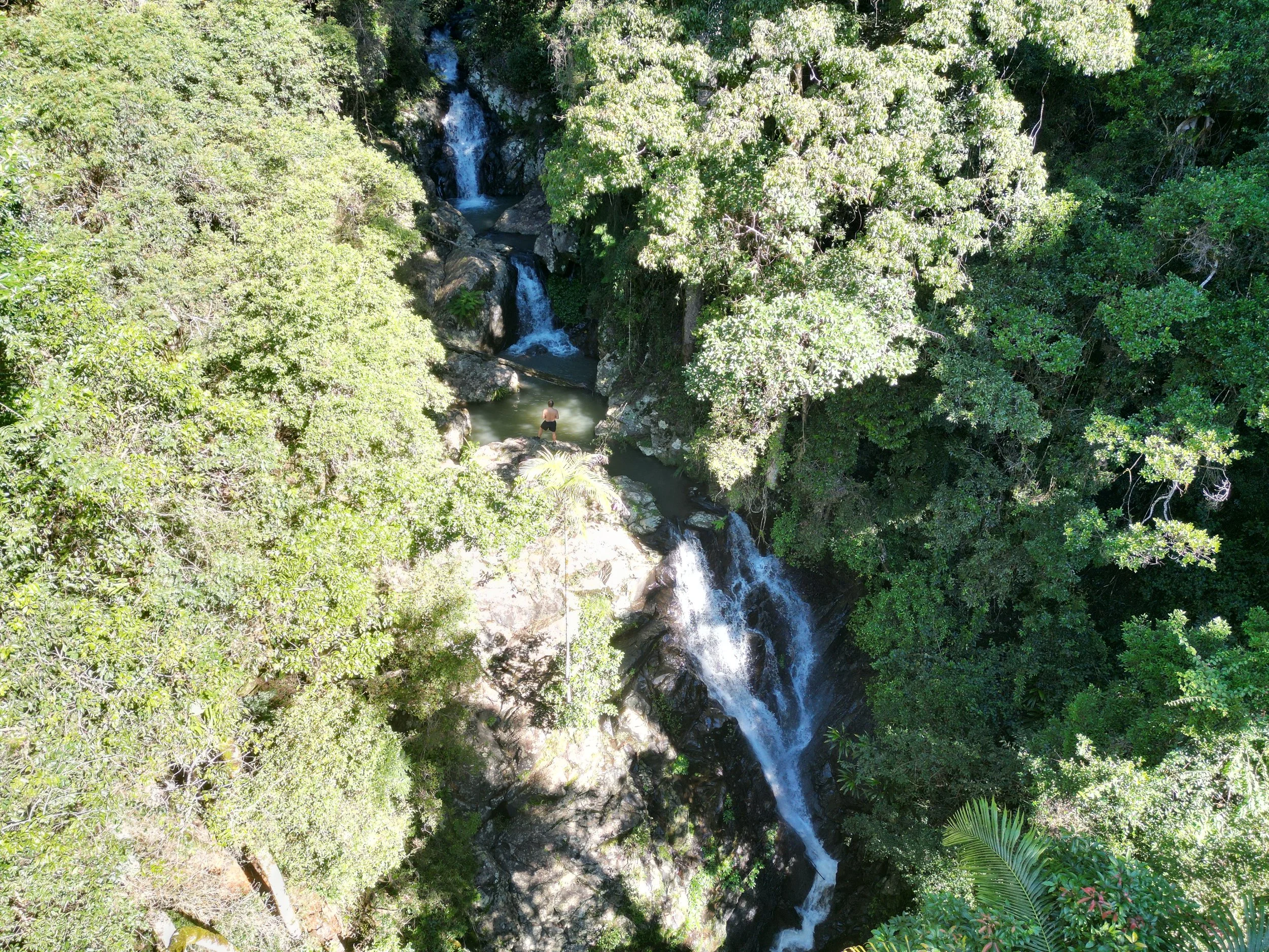 Thomas surrounded by waterfalls and rainforest.