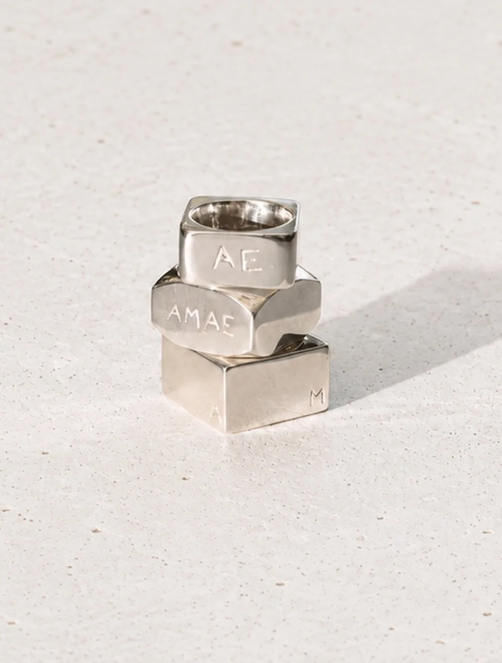 3 square rings, 3 different shapes, 4 letters: AMAE.

A few weeks ago, my dear friend @aliasbandofficial asked me to design 3 square rings, each engraved with his family&rsquo;s initials.

We chose 3 different shapes to create a fun combination of ch