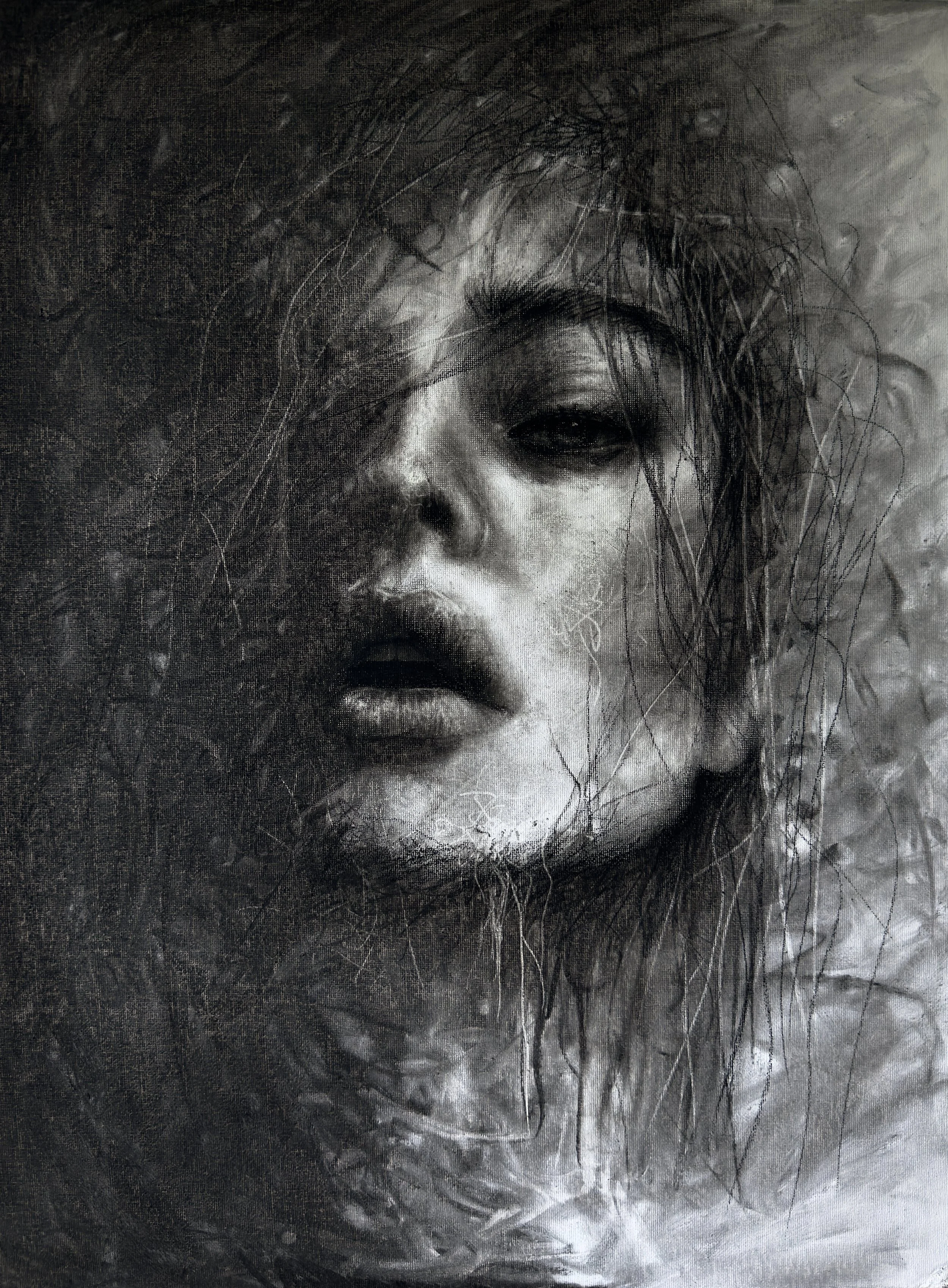 A black and white artistic portrait of a woman with wet and tousled hair, with an intense expression.