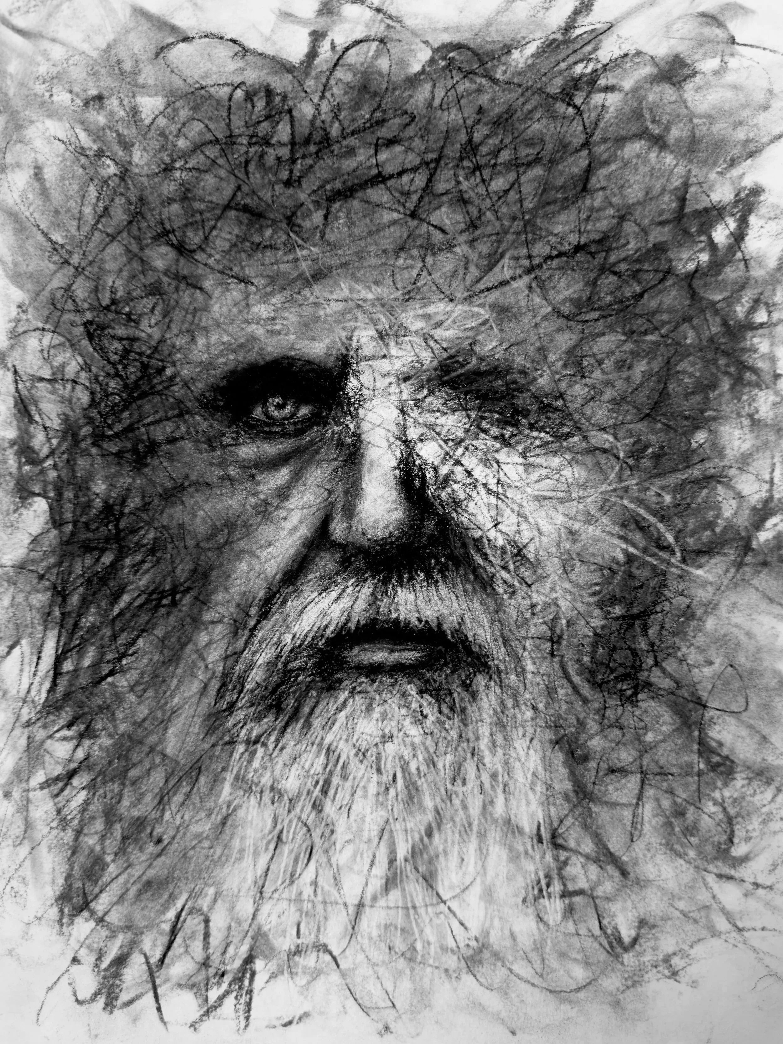 A black and white abstract drawing of an old weathered man's face with intense eyes, created with various scribbles and shading.