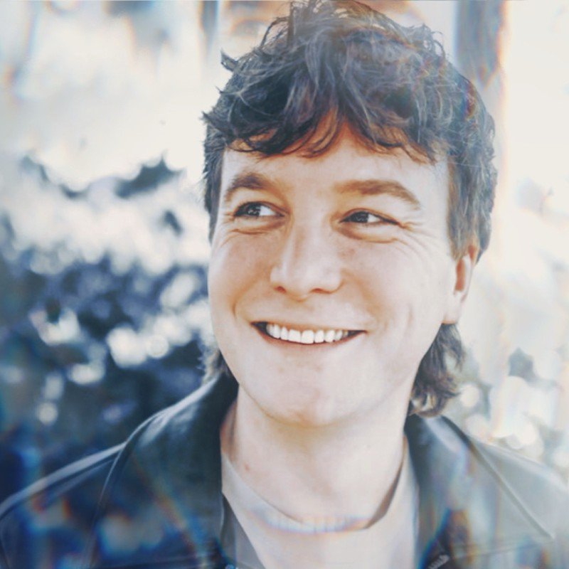 Zac Hunter, founder of Thelemata, smiling in a leather jacket