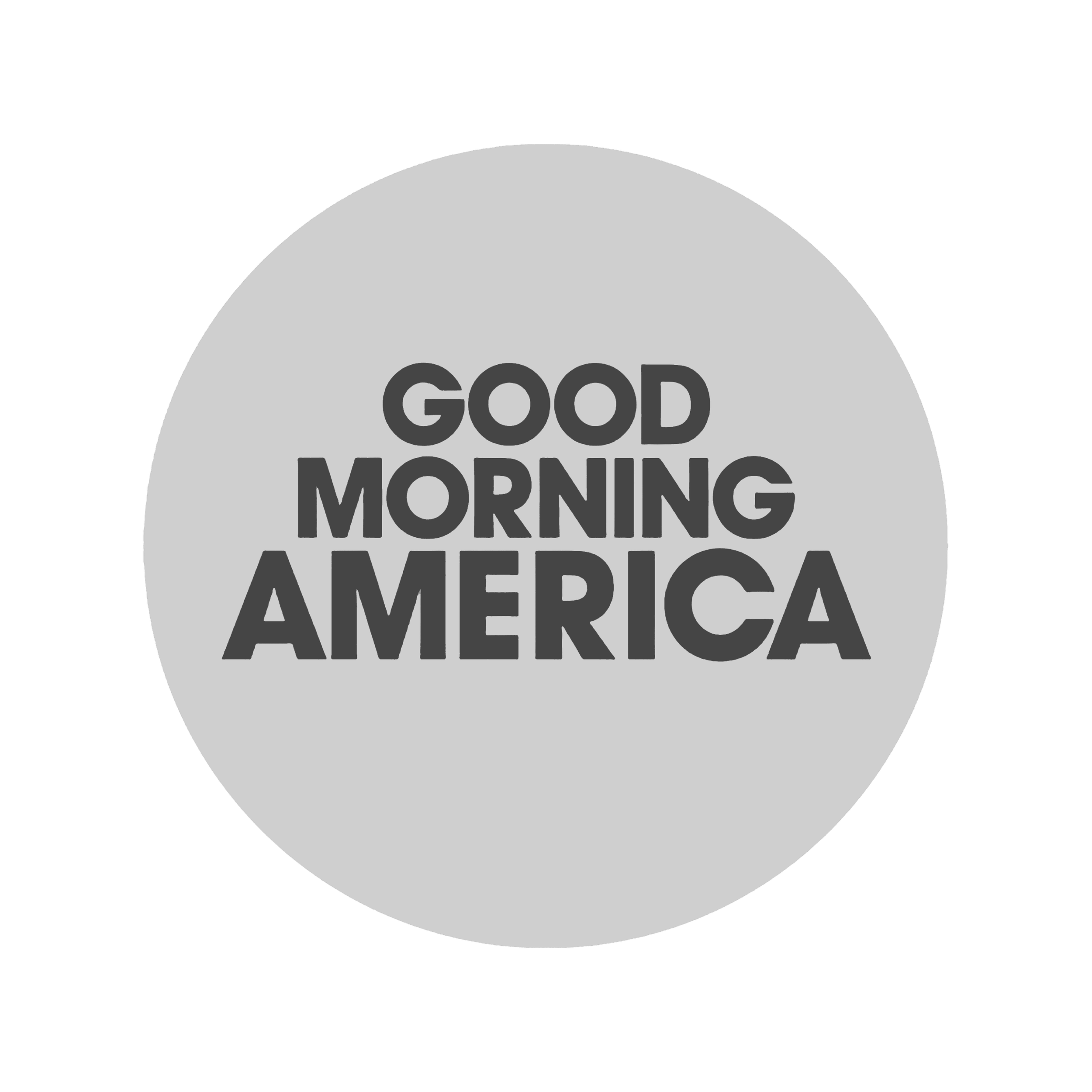 Gray circular sign with black text reading 'Good Morning America' on it, against a black background.