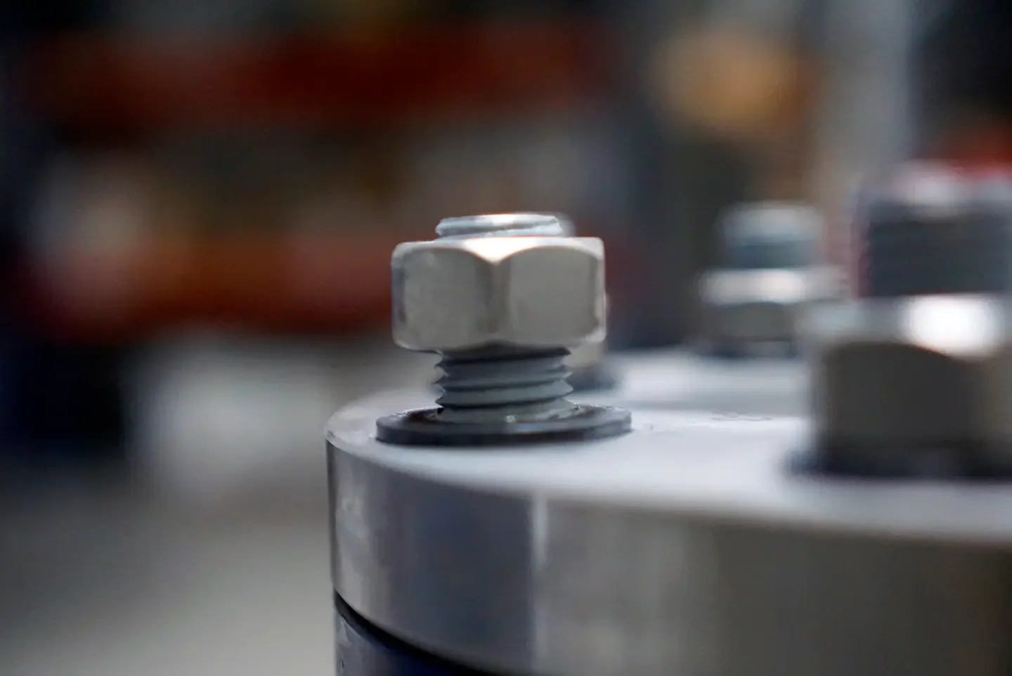 Close-up of metallic bolt and nut on a machine or piece of equipment