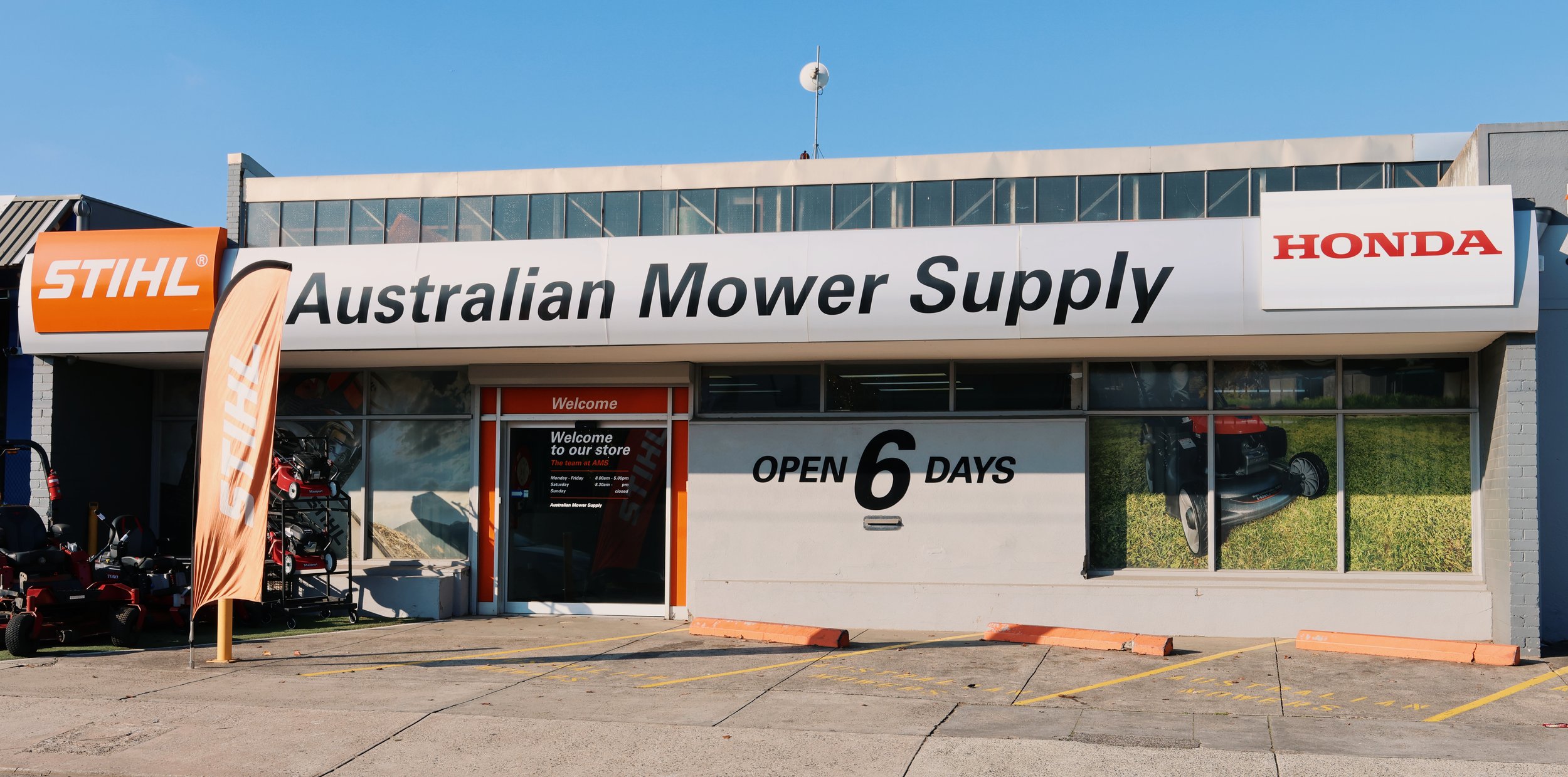 Storefront with signs for Australian Mower Supply, STIHL, and Honda. Store offers outdoor power equipment and mowers, open 6 days a week.