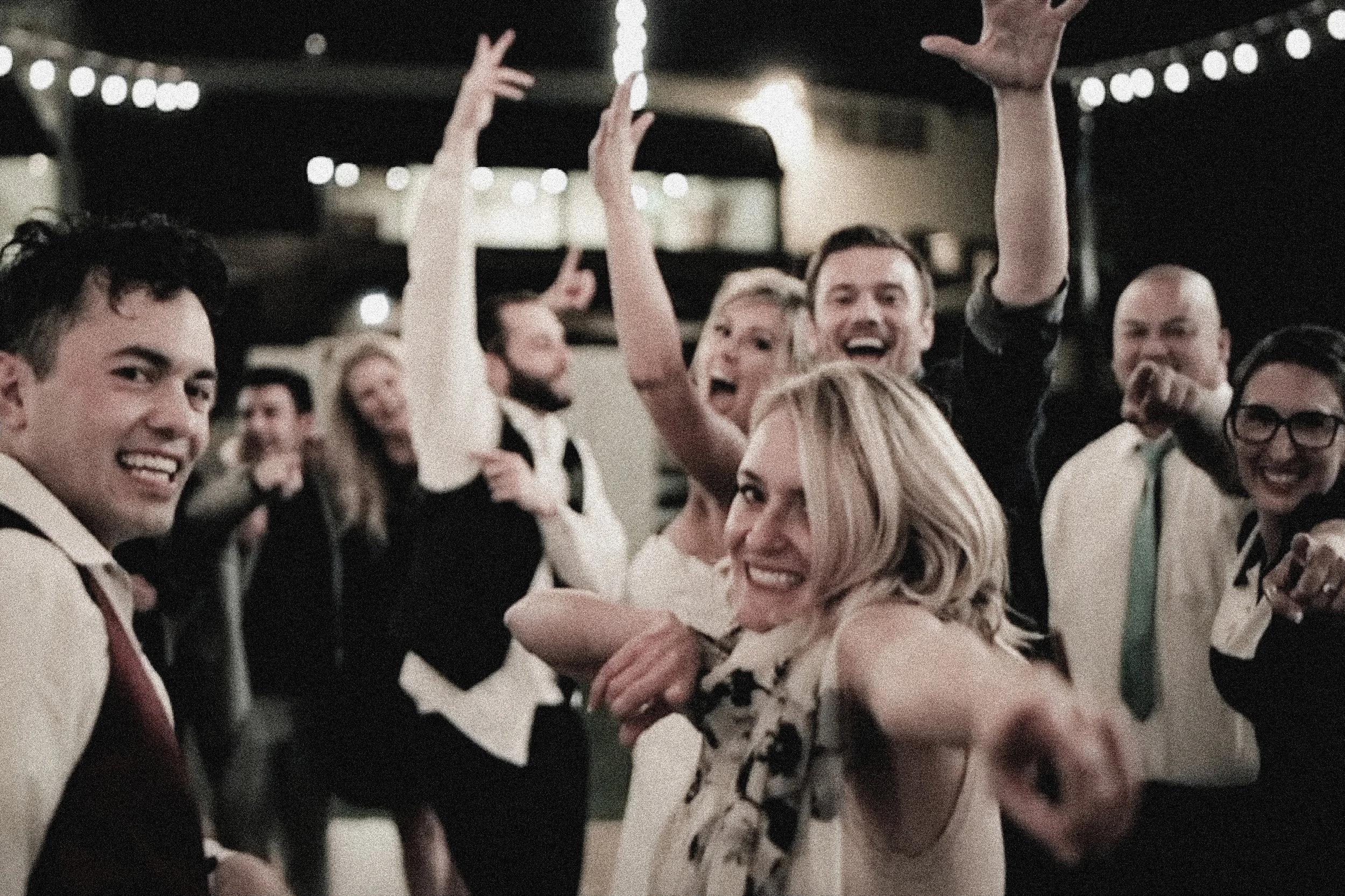 Brittany and Chason celebrating with friends on the dance floor at Valencia Country Club
