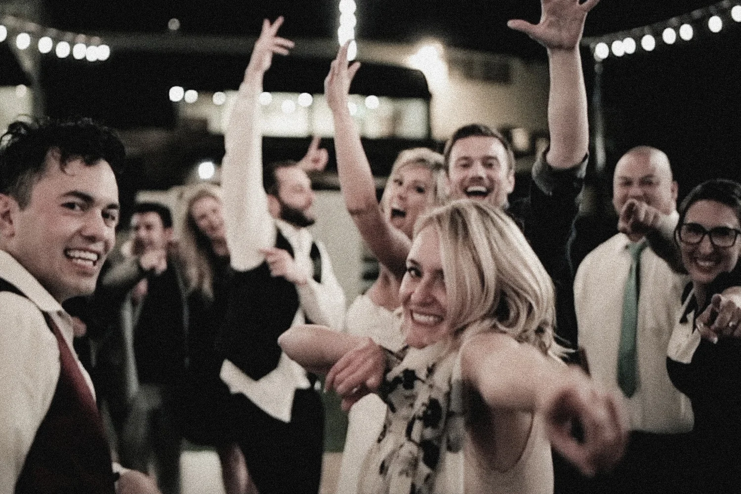 Brittany and Chason celebrating with friends on the dance floor at Valencia Country Club
