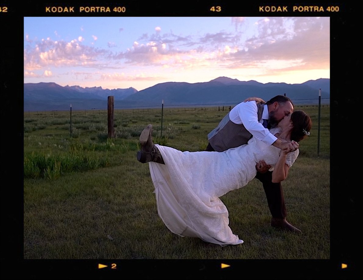 Kelly & Bryan celebrate their wedding day by kissing in front of the Sierra Nevada mountains at Bridgeport Ranch Barns & Terrace, Bridgeport CA