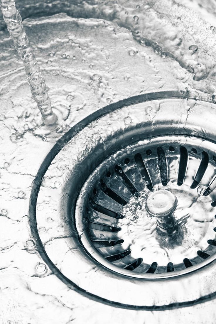 Water flowing freely into a clean sink drain after professional drain cleaning service.