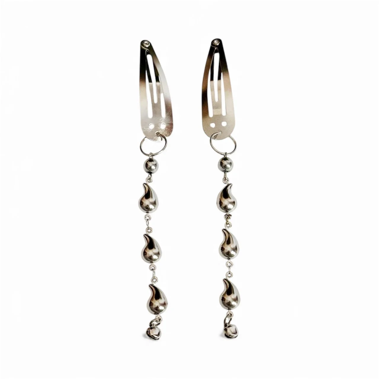 Architectural silver earrings transforming hair clips into wearable art with cascading teardrop elements and crescent moon charms