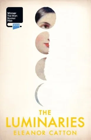 The cover of the book "The Luminaries" by Eleanor Catton, featuring a face with eyes, nose, and mouth in a minimalist, abstract style.
