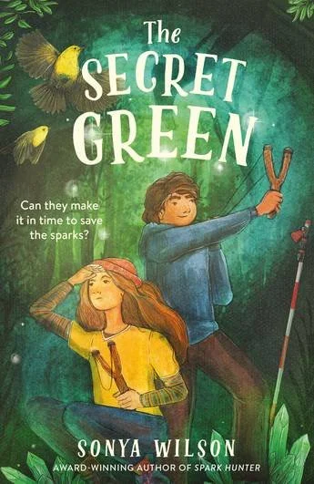 Book cover of 'The Secret Green' by Sonya Wilson, featuring a girl with long red hair holding a torch and a boy with curly brown hair holding branch-like sticks, with two yellow birds flying above. The background is a lush green forest.