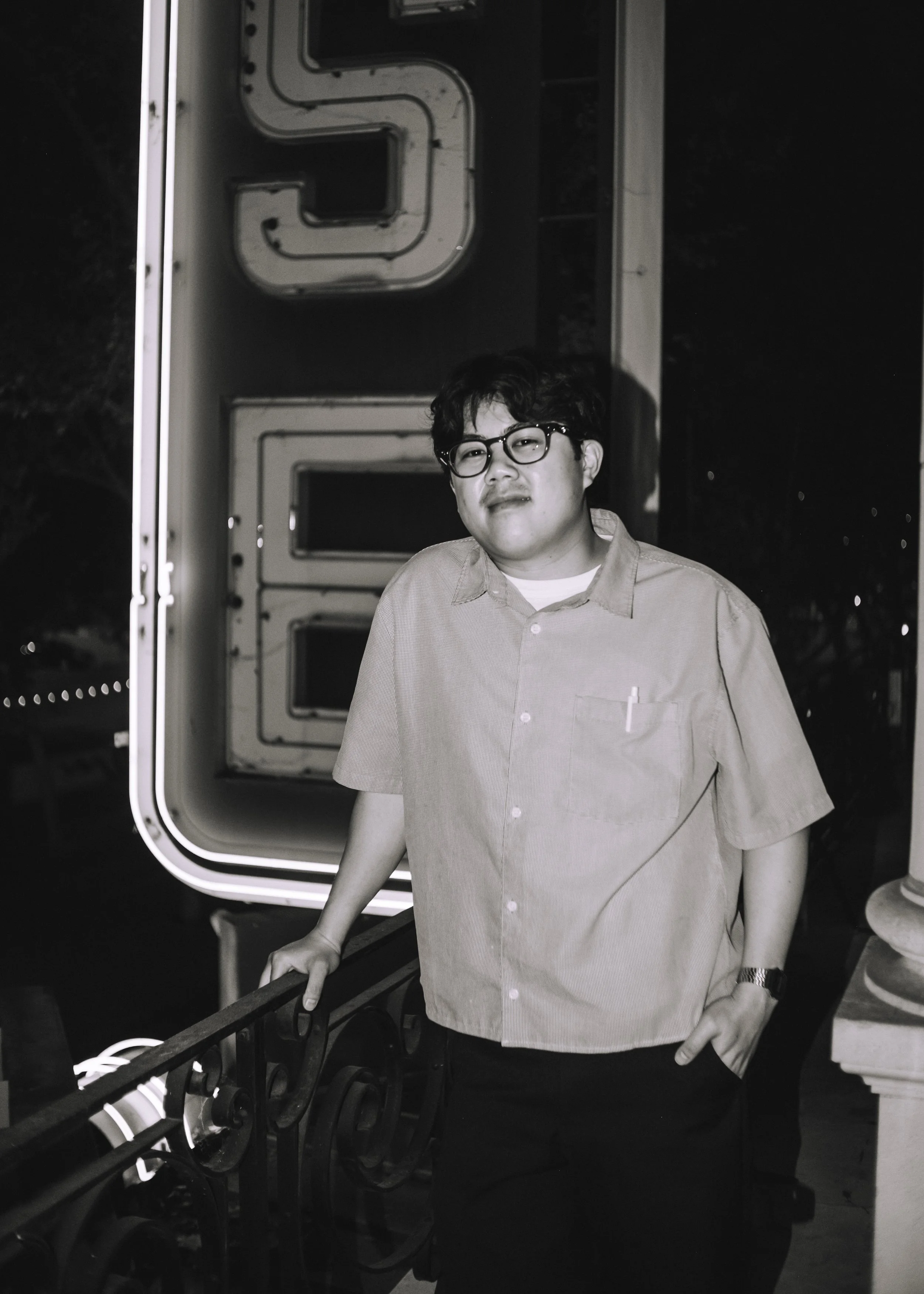 Comedian Peter Bui standing outside on the balcony of the San Jose Improv.