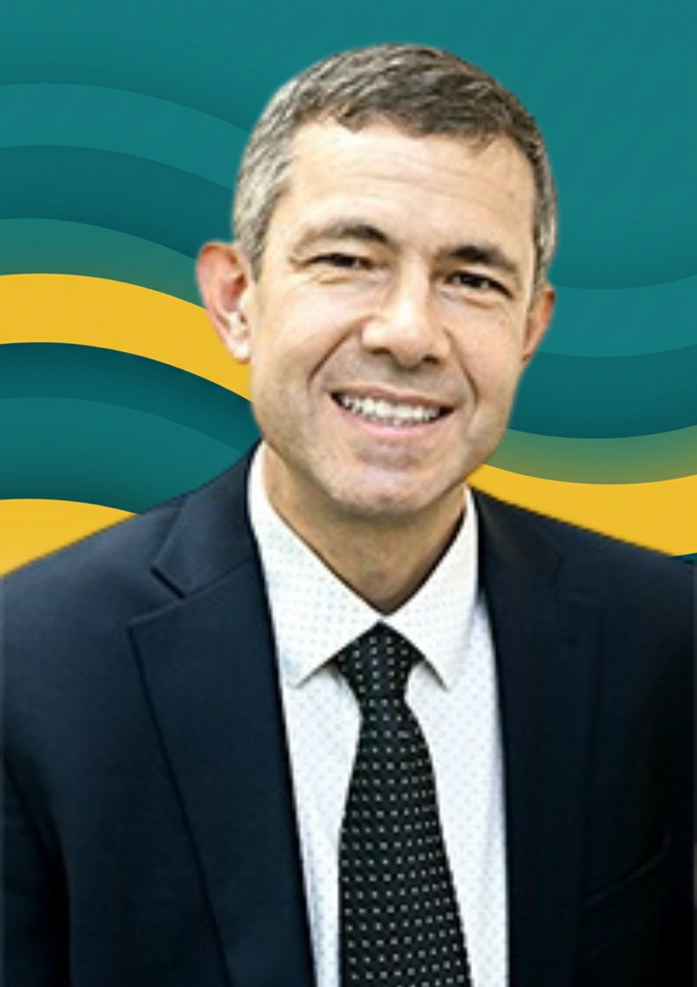A smiling man in a dark suit, white shirt, and polka dot tie against a background with yellow and green wavy stripes.
