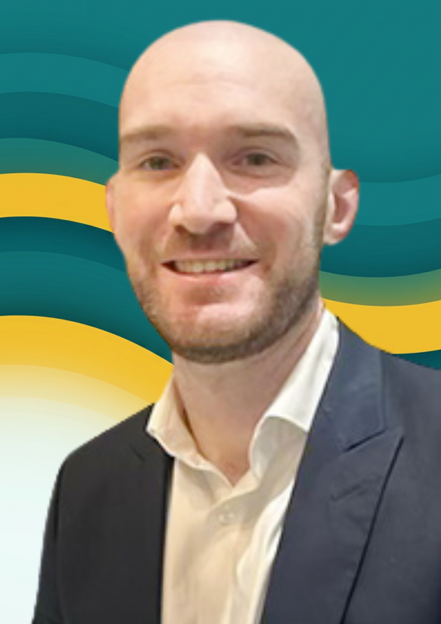 Close-up of a smiling man with a shaved head, wearing a suit and white shirt, against a background of blue and yellow abstract waves.