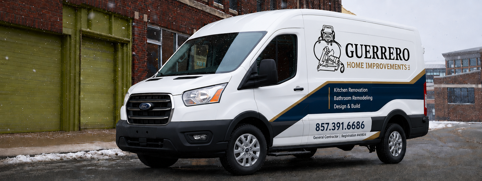 White GUERRERO HOME IMPROVEMENTS van parked on the street in winter, with snow on the ground. The van’s side displays the company's logo, contact number, and services including kitchen renovation, bathroom remodeling, and design & build.