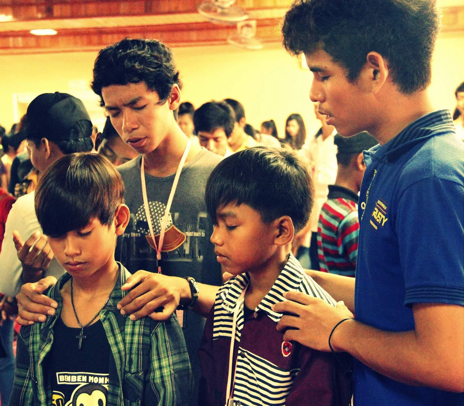 Sros (in blue) and Piset at an Alongsiders camp prayer time.