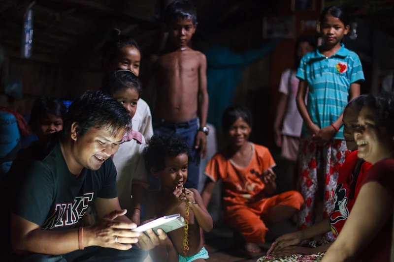 Phearom uses a low-end Samsung tablet to enter the names and details of the new Alongsiders and their little brothers and sisters in an Android app. Each participant is photographed. This information is then uploaded to an online database when he ha…