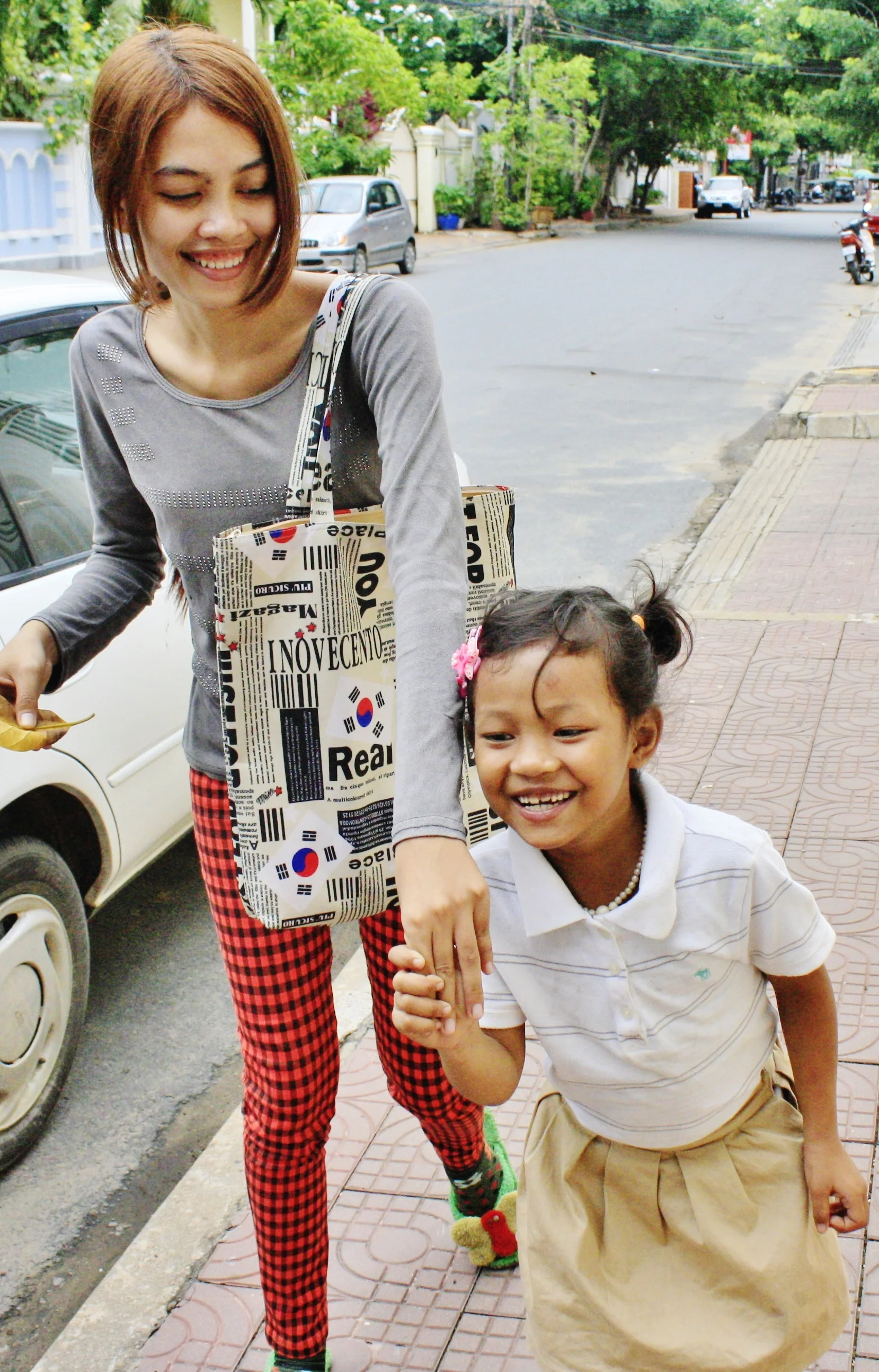 Karuna (left), now 21 years old with her own "little sister"