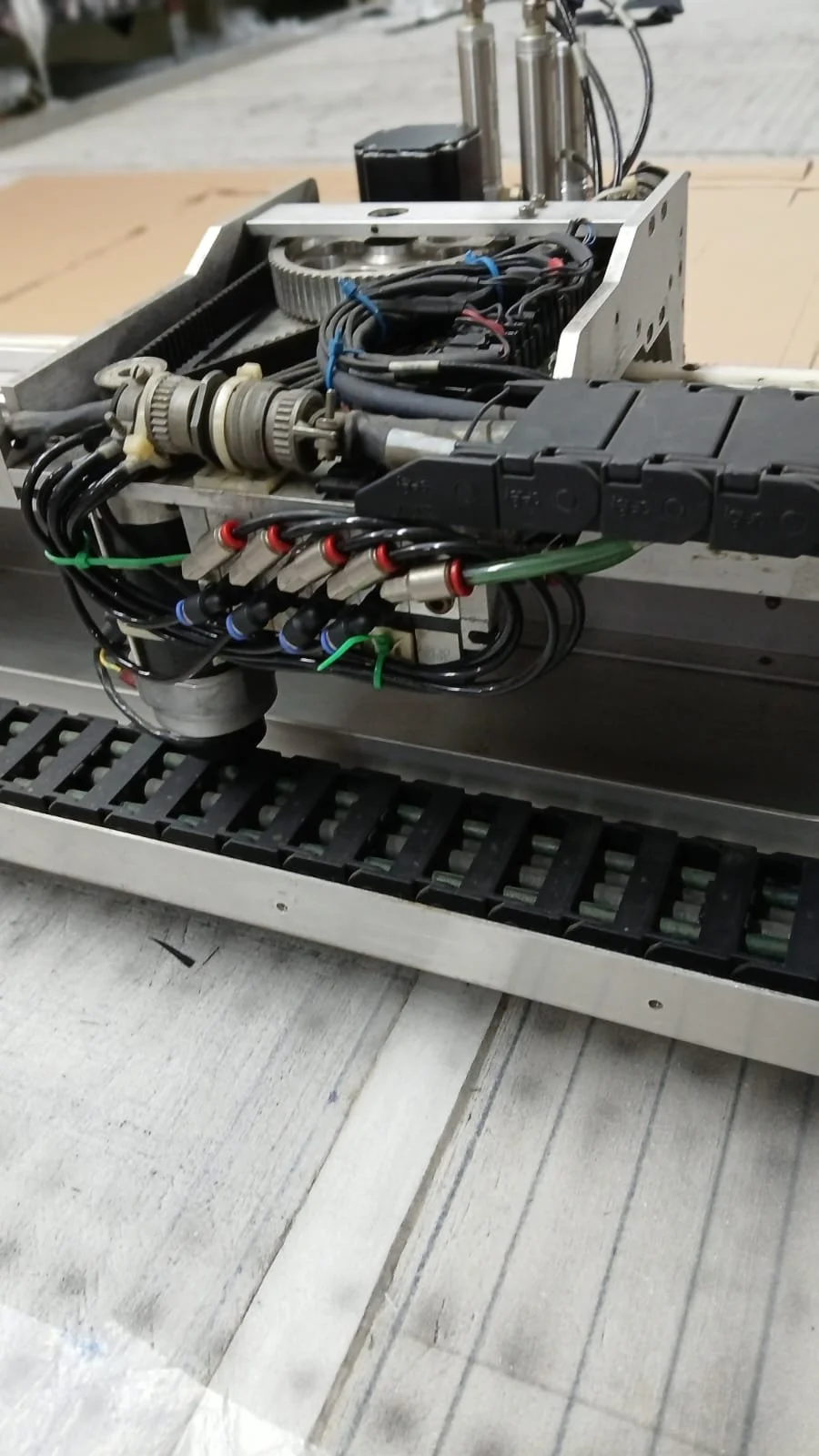 Close-up of an industrial machine's internal components, including wiring, gears, and mechanical parts.