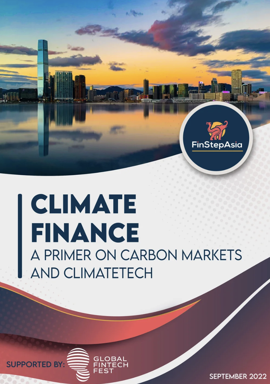 Cover of a report titled 'Climate Finance: A Primer on Carbon Markets and Climatetech,' featuring a city skyline at sunset with buildings reflecting on a body of water, and a logo for FinStepAsia in a circular badge with a stylized pink dragon. The report is supported by Global Fintech Fest, dated September 2022.