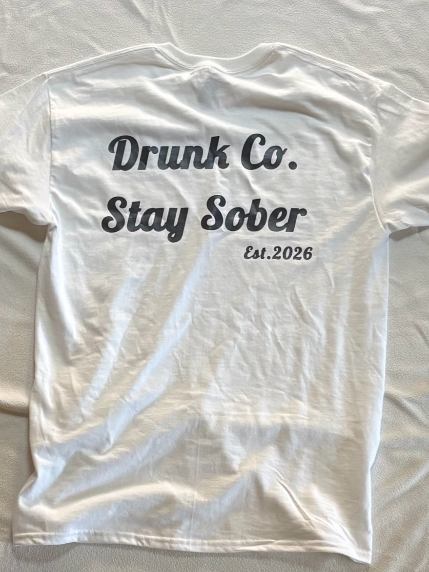 White T-shirt with black text that reads 'Drunk Co. Stay Sober Est. 2026'.