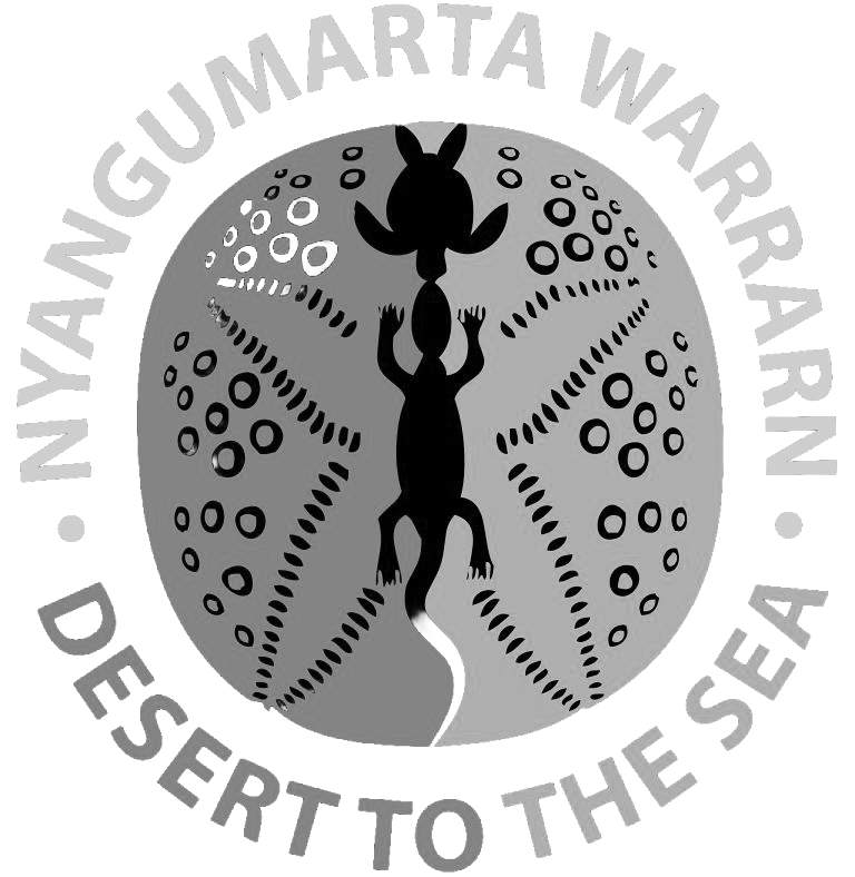 Logo with a circular design featuring a stylized gecko and the words 'Navajo Gumi Art Warrn' and 'Desert to the Sea' encircling the image.
