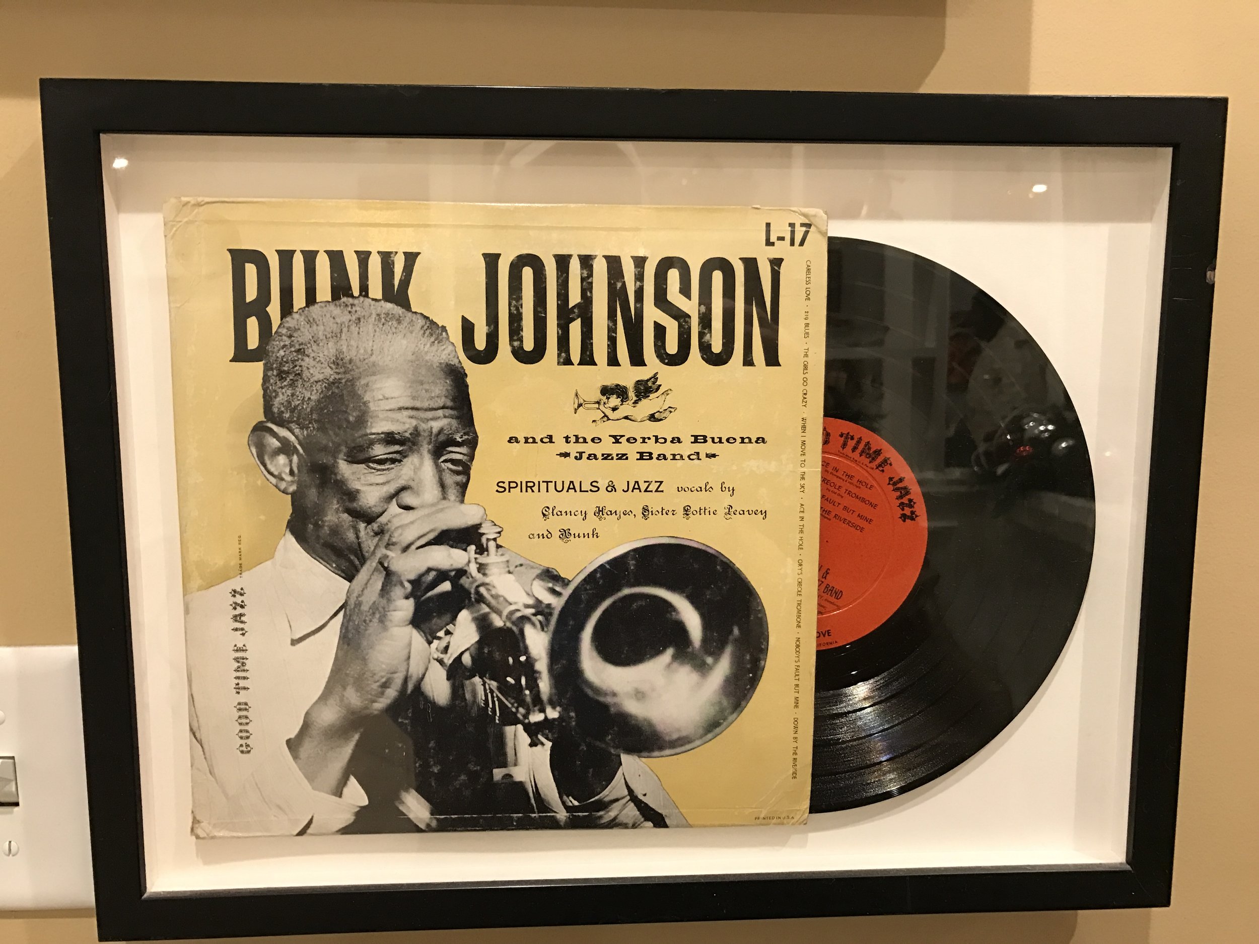 Framed Bunk Johnson LP on the American Music label with a photograph of him playing trumpet