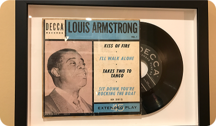 Framed Louis Armstrong Decca extended play 45 RPM sleeve with its record