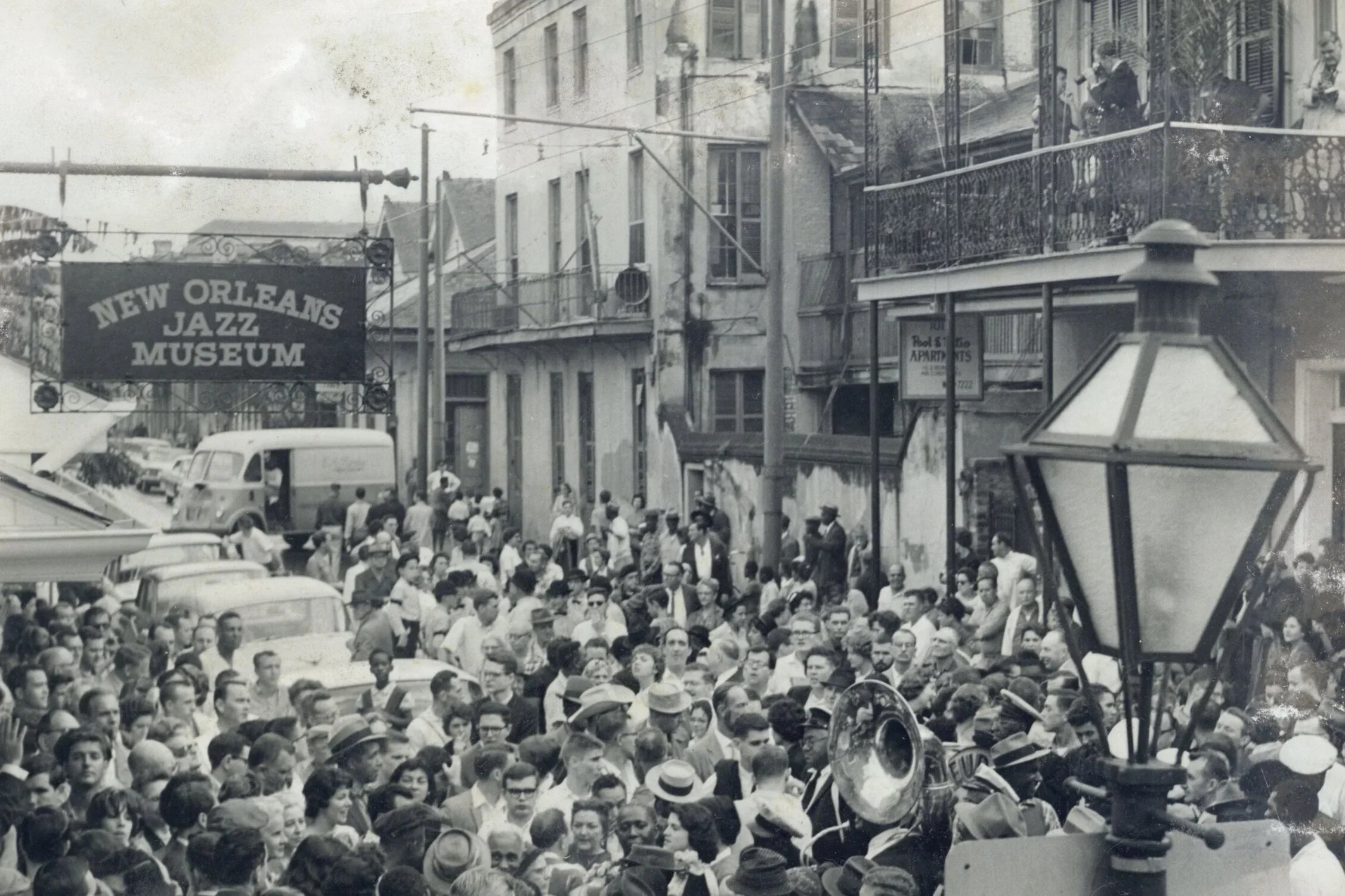 Crowd filling the street beneath the New Orleans Jazz Museum banner on opening day, 1961