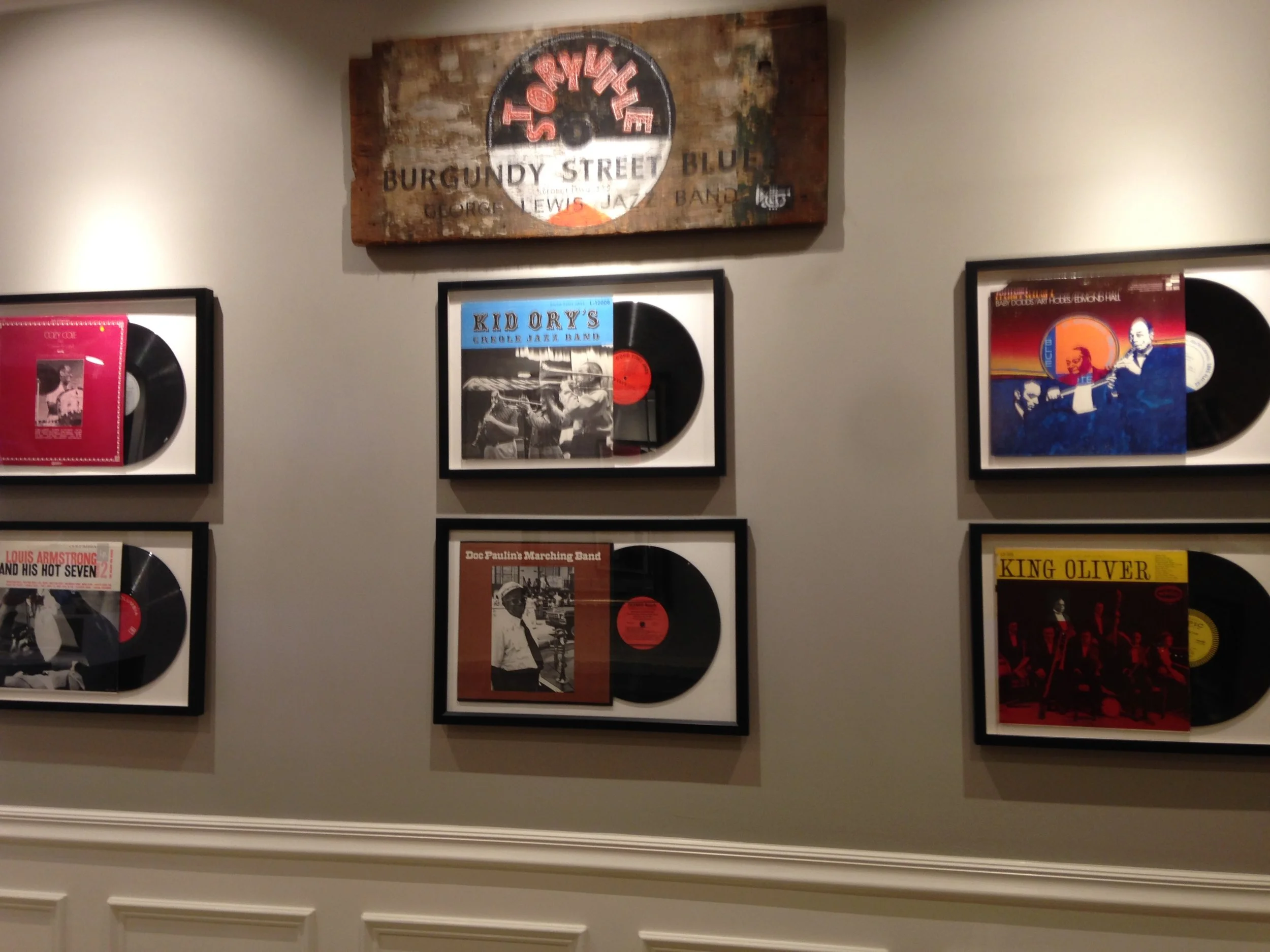 Wood-mounted Storyville Records label for Burgundy Street Blues above two framed LPs