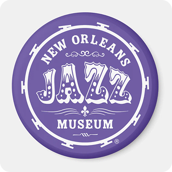 Round purple magnet with the museum's drum logo