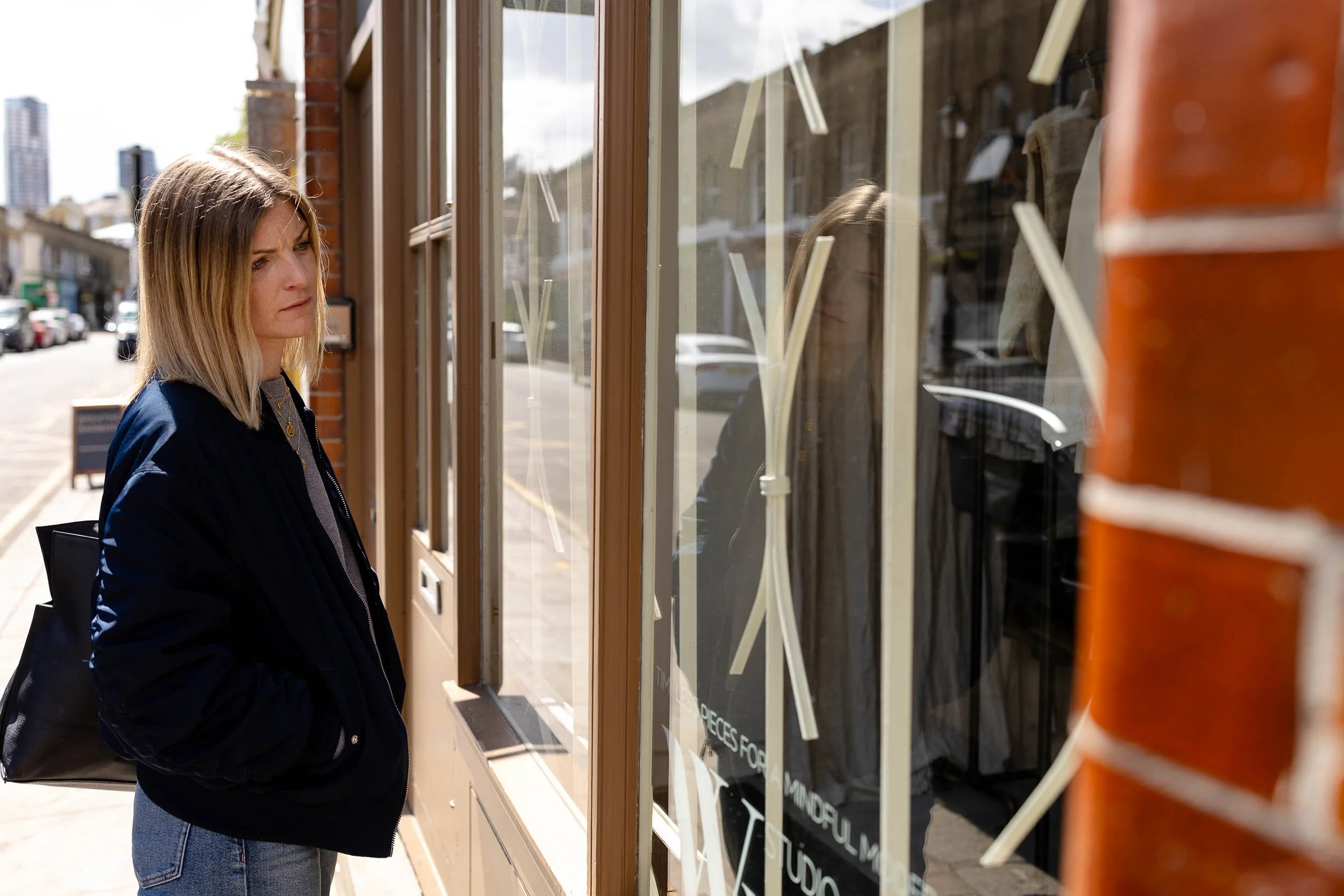 Retail consultant reviewing fashion brand window display