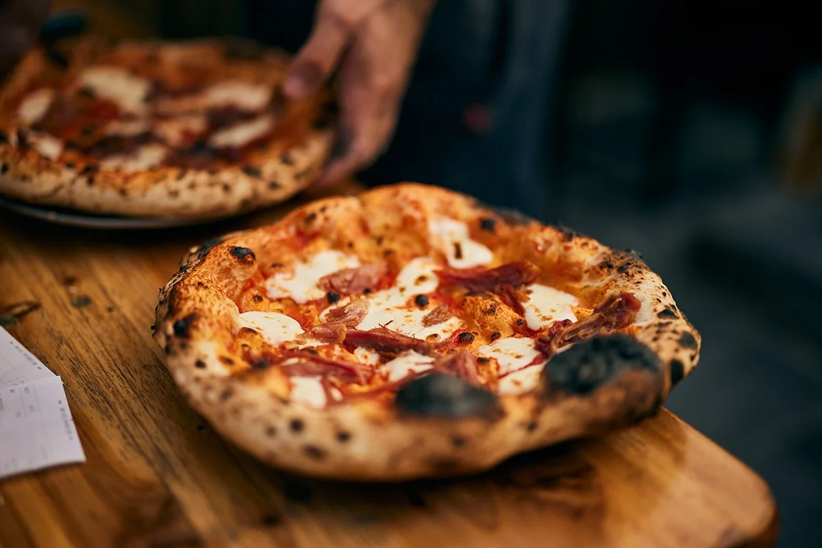 close-up-of-a-pizza-maker-serving-fresh-baked-pizz-2026-03-31-23-11-50-utc.jpg