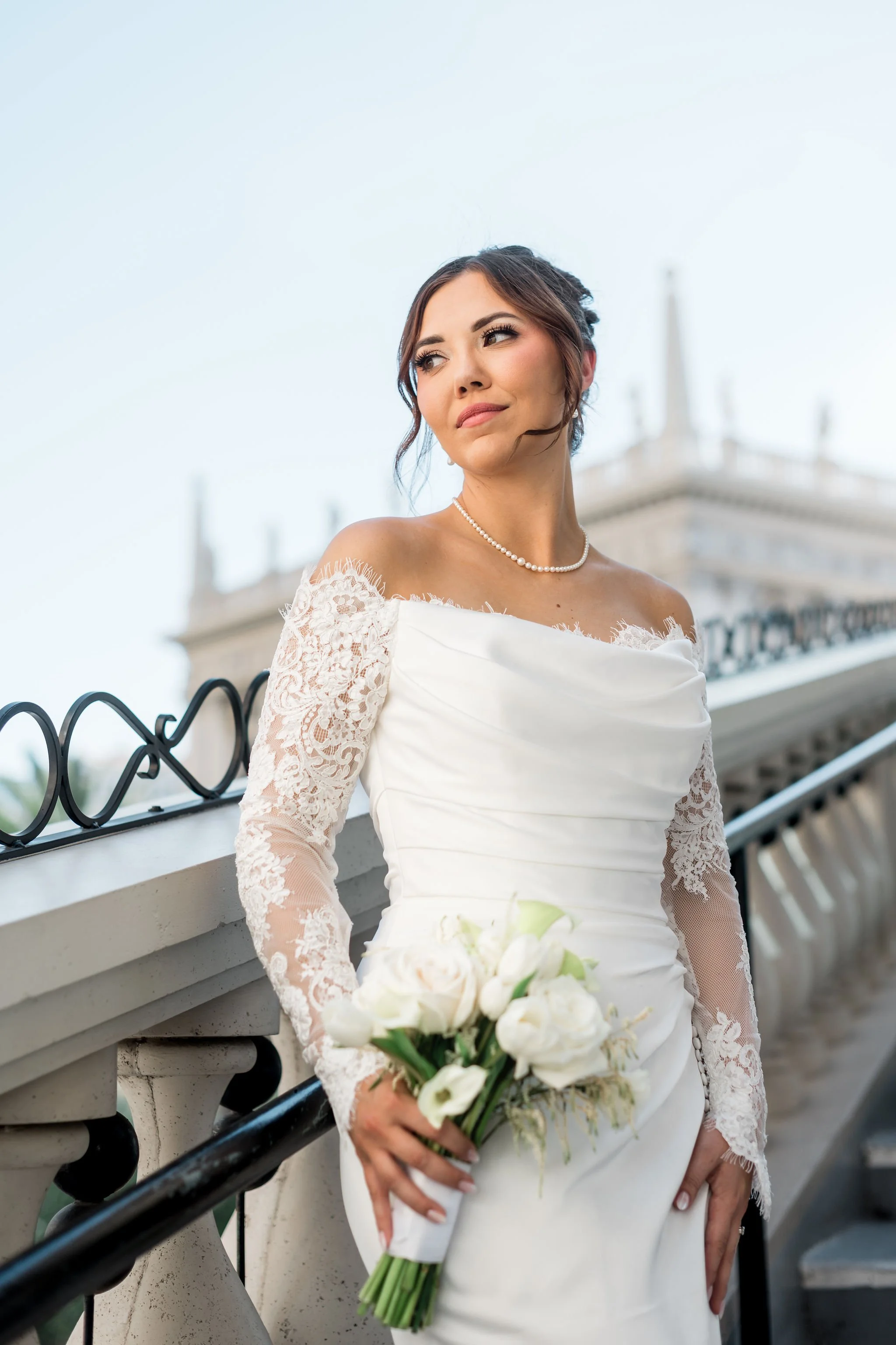 Bridal portrait of Jessica with white bouquet on The Venetian Las Vegas exterior staircase, hair by Katie and makeup by Aimee for Amelia C & Co, photography by Liz Le