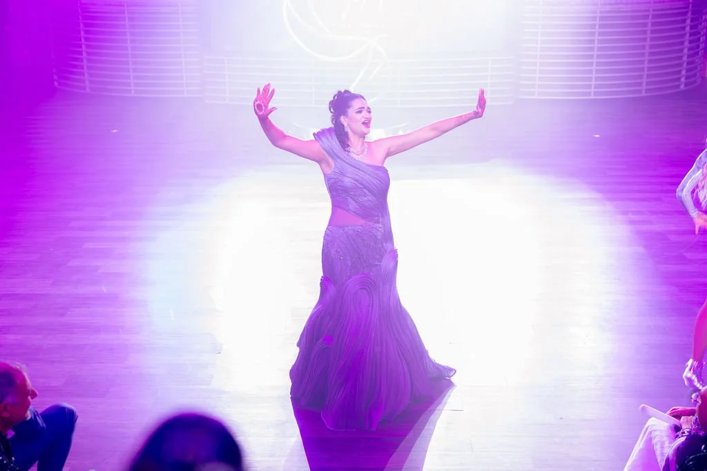Indian bride in lavender embellished gown with dramatic stage entrance at Las Vegas engagement party, hair by Karen K and makeup by Natalia W for Amelia C & Co, photography by Elizabeth Burgi