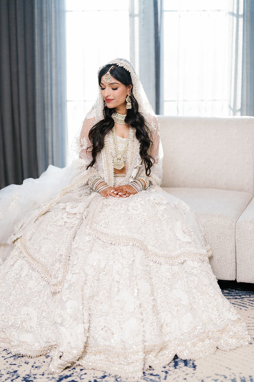 Close-up bridal beauty portrait of Trusha with maang tikka, jhumka earrings, and smoky eye at JW Marriott Las Vegas wedding, hair by Courtney and makeup by Natalia for Amelia C & Co, photography by Chernogorov Photography
