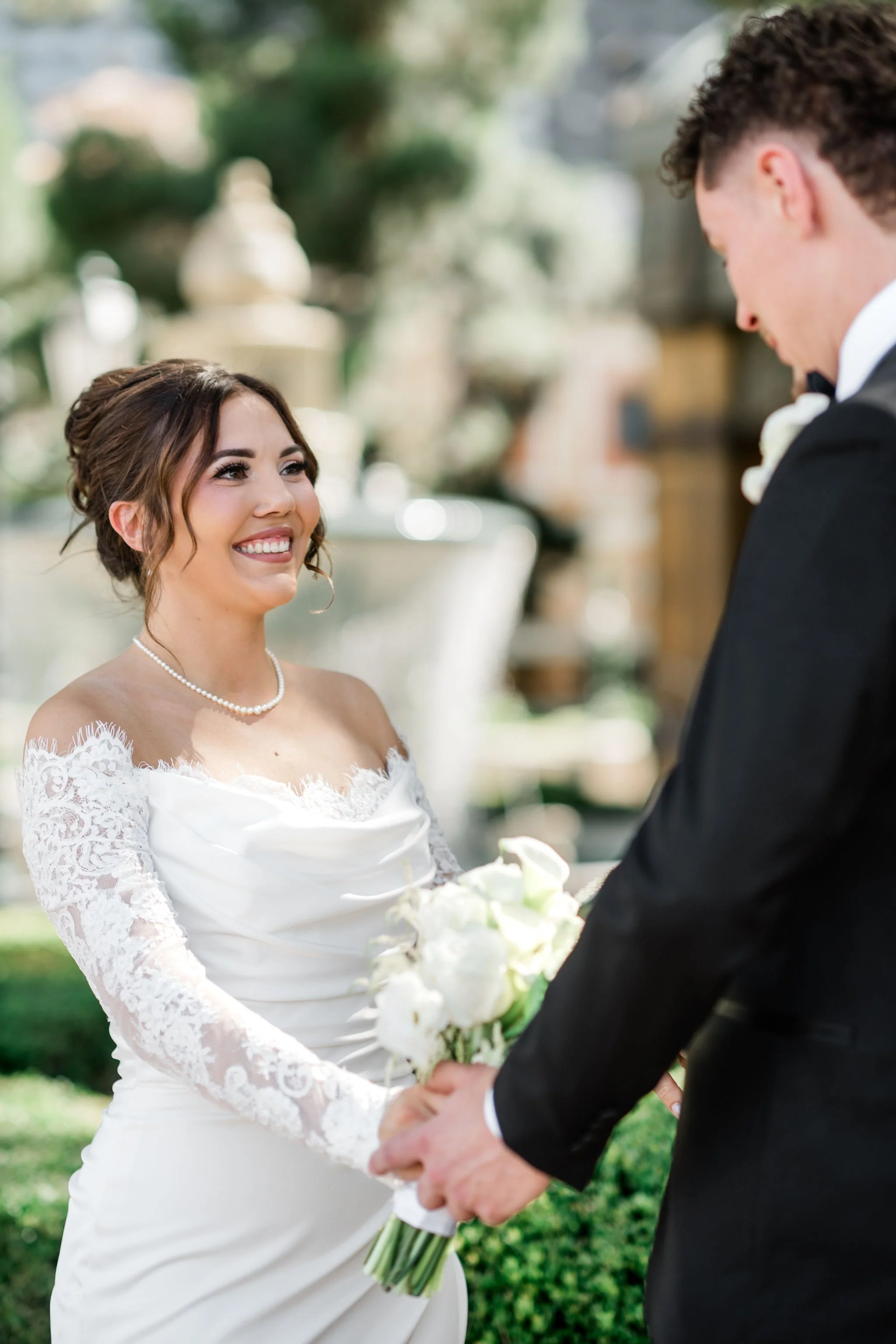 Bride Jessica smiling at groom Lukas during first look at Hard Rock Hotel Las Vegas wedding, hair by Katie and makeup by Aimee for Amelia C & Co, photography by Liz Le