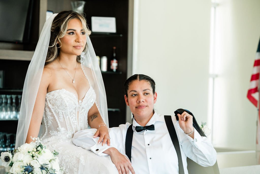 Full length bridal portrait of Joselynn in lace corset gown with veil and train at Las Vegas LGBTQ+ wedding, hair and makeup by Hailee for Amelia C & Co, photography by Cactus Collective Weddings