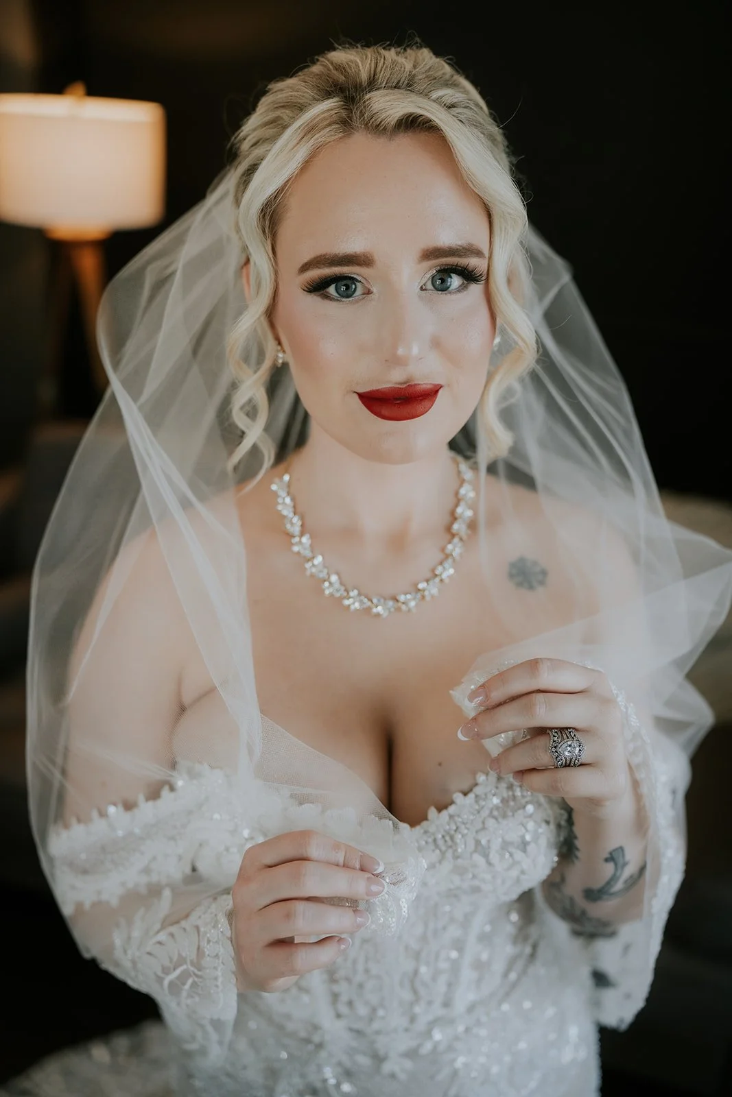 Close-up portrait of bride Naomie with veil and red lip looking directly at camera at Wedgewood Weddings Stallion Mountain wedding, hair by Courtney and makeup by Natalia for Amelia C & Co, photography by Stephen Salazar