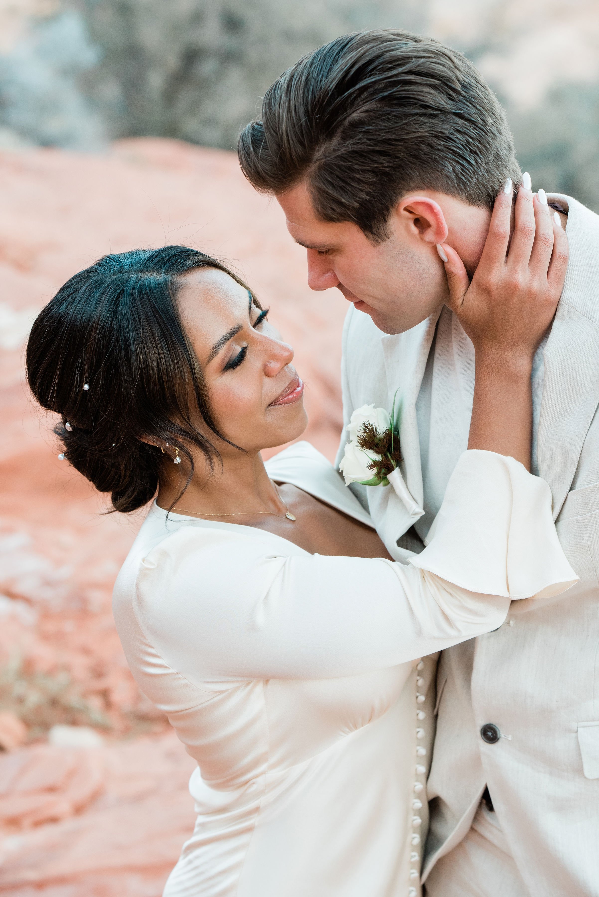 Close-up of Martinique and James almost kissing at Red Rock Canyon elopement, hair and makeup by Luci for Amelia C & Co, photography by Cactus Collective Weddings