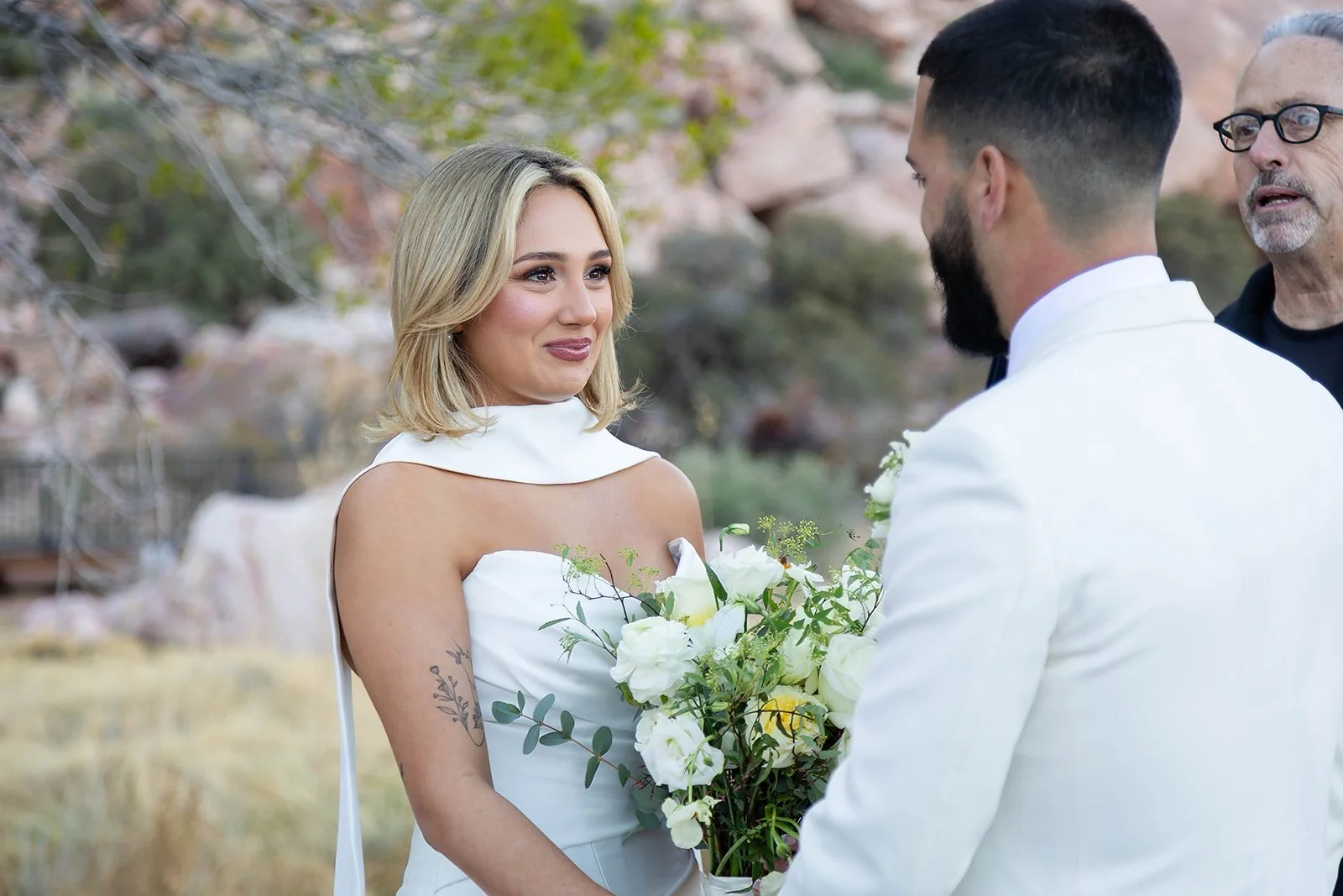 Close-up of Melysa looking at Carlos during ceremony at Red Spring Boardwalk Las Vegas elopement, emotional bridal beauty portrait, hair by Luci and makeup by Natalia for Amelia C & Co, photography by Onyx & Arrow