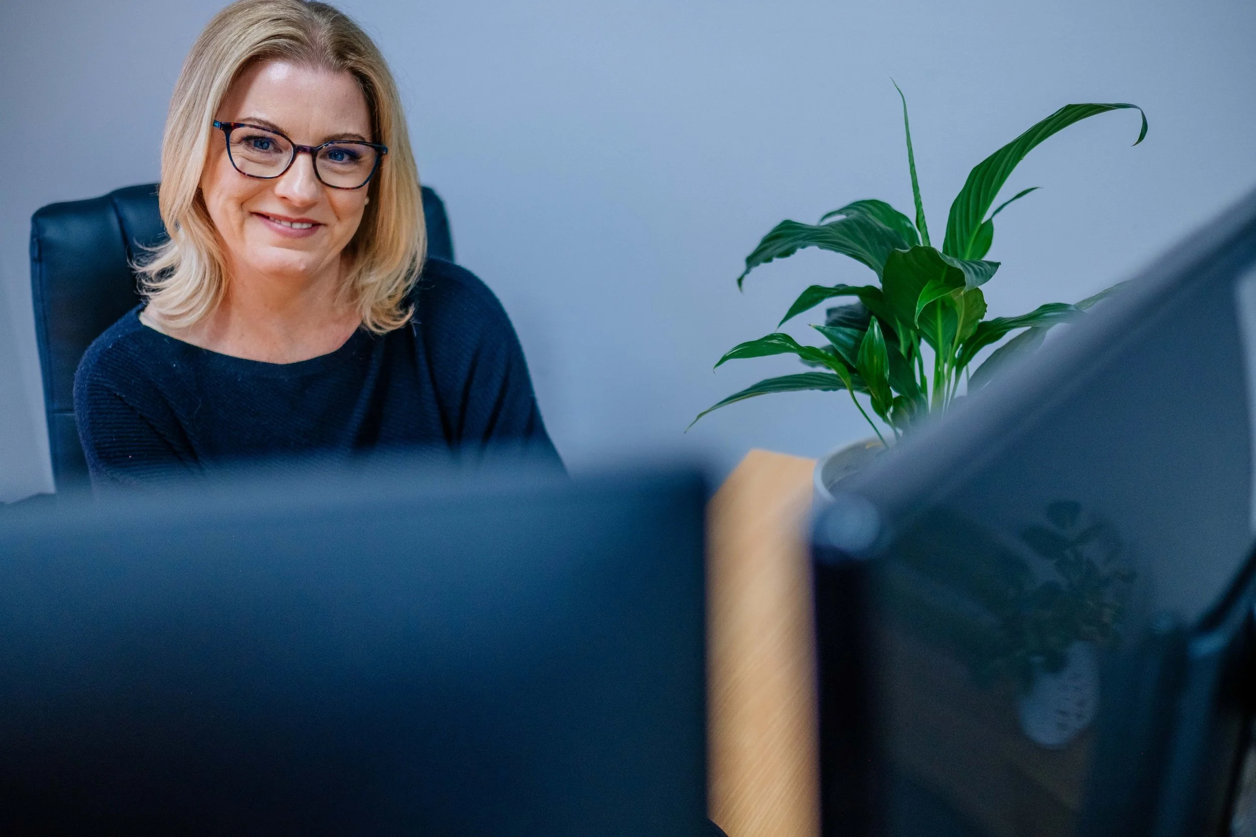 Headshot of Michelle Redman from Redman Bookkeeping Solutions. She is wearing a black top, glasses, and a big smile. Michelle has shoulder-length blonde hair. She is helping Denmark and Albany WA business owners streamline their bookkeeping and BAS.