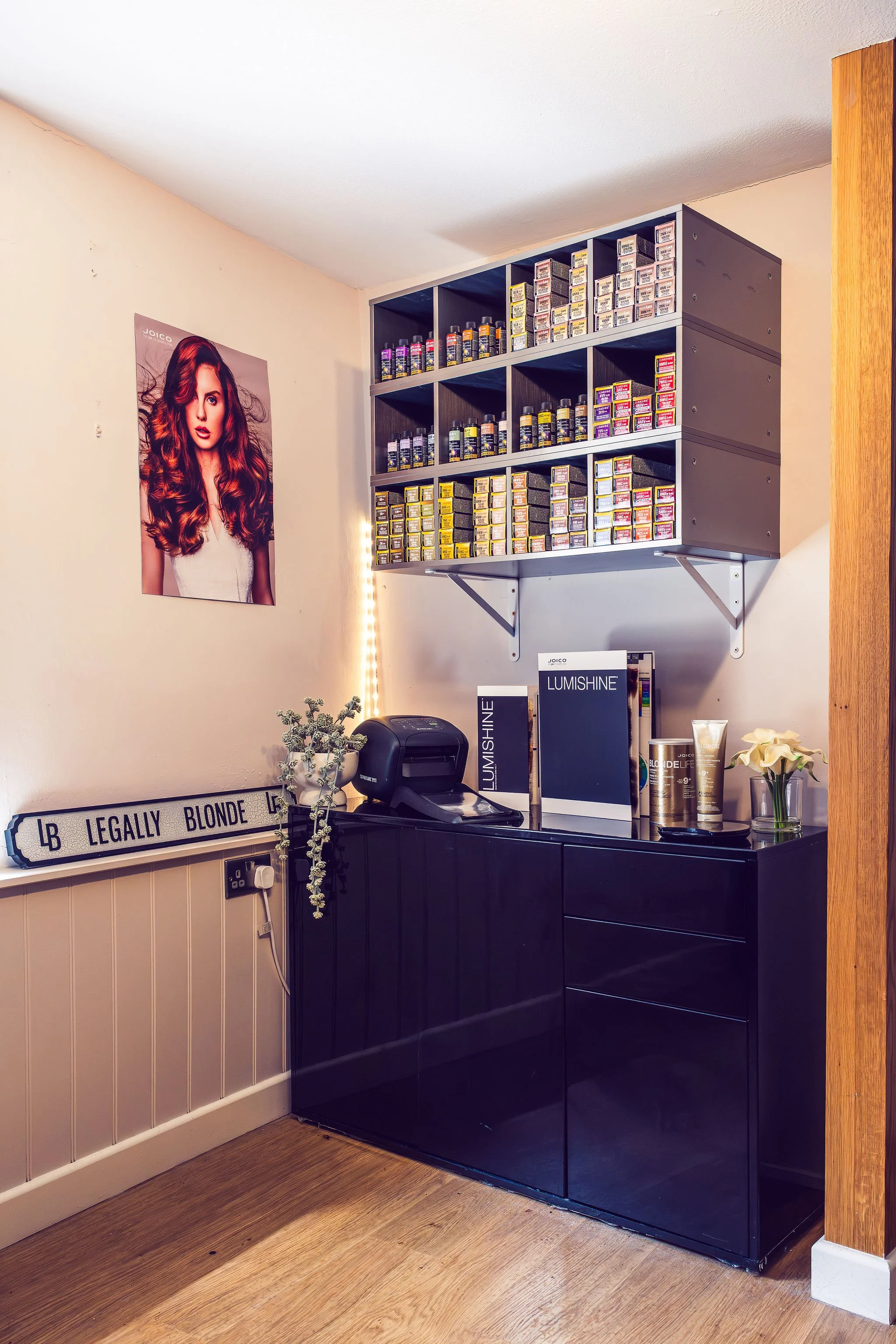 The salon colour station. A display shelf filled with colour products in the salon.
