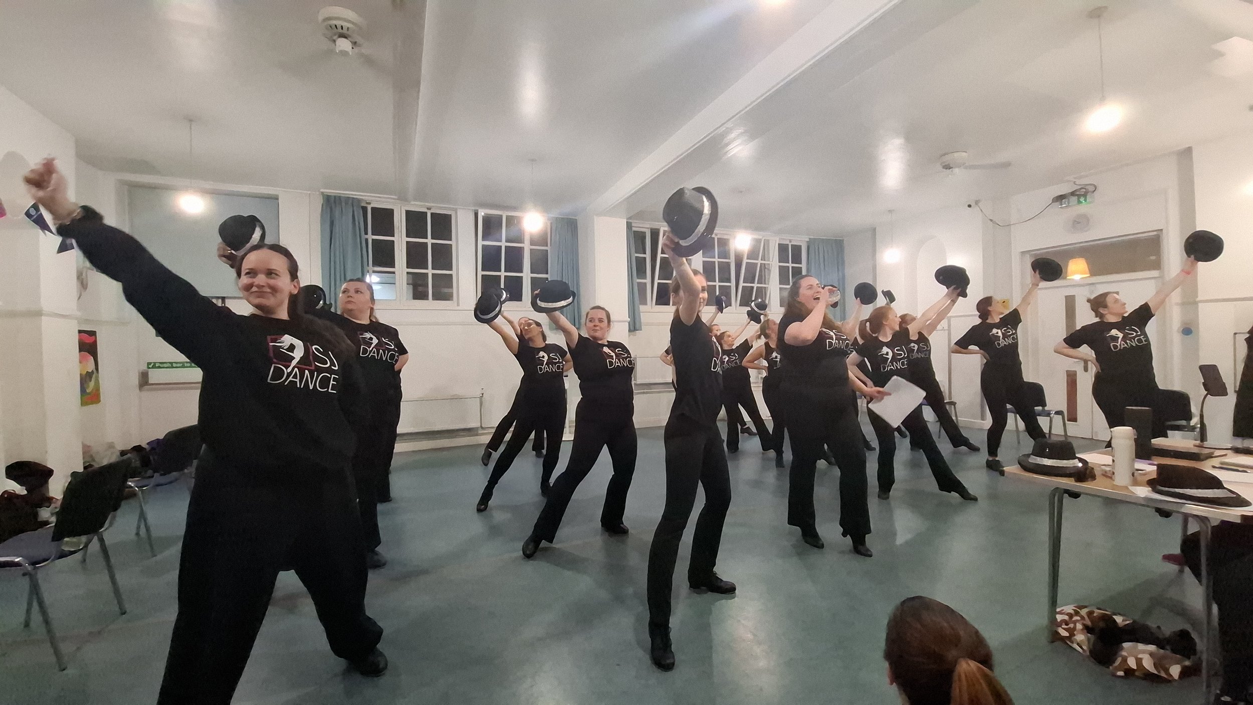 Tap dancers with hats rehearsing a dance